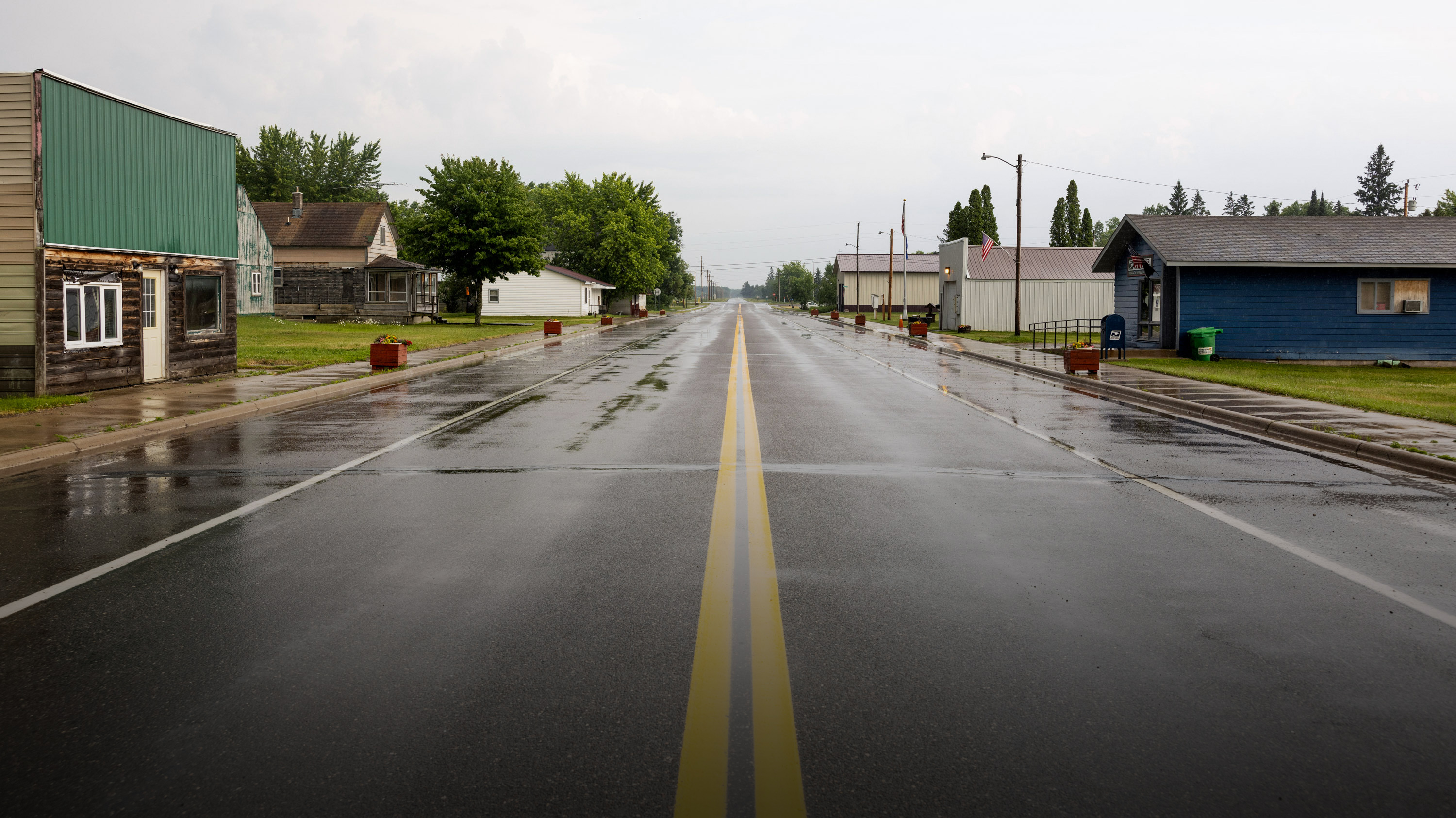 A view from the median line of an empty Main Street, Tamarack MN after a recent rain shower